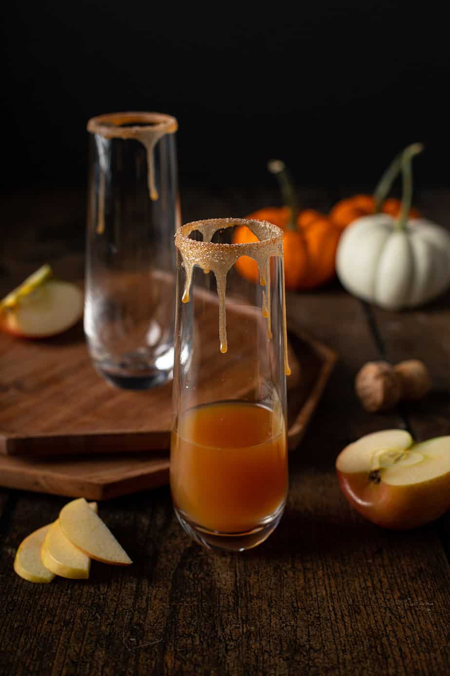 a stemless champagne flute with apple cider