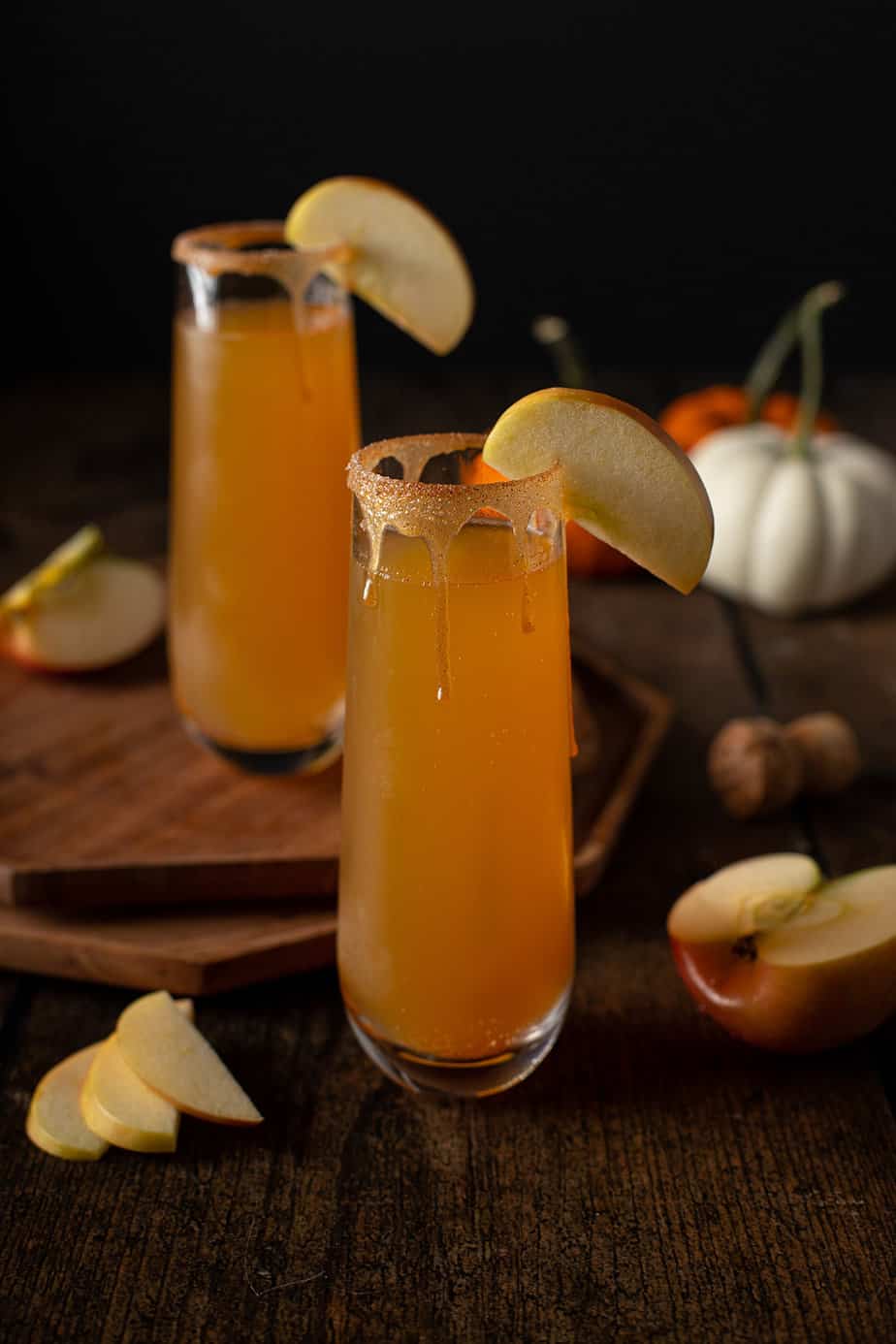 two stemless champagne flutes of apple cider mimosas