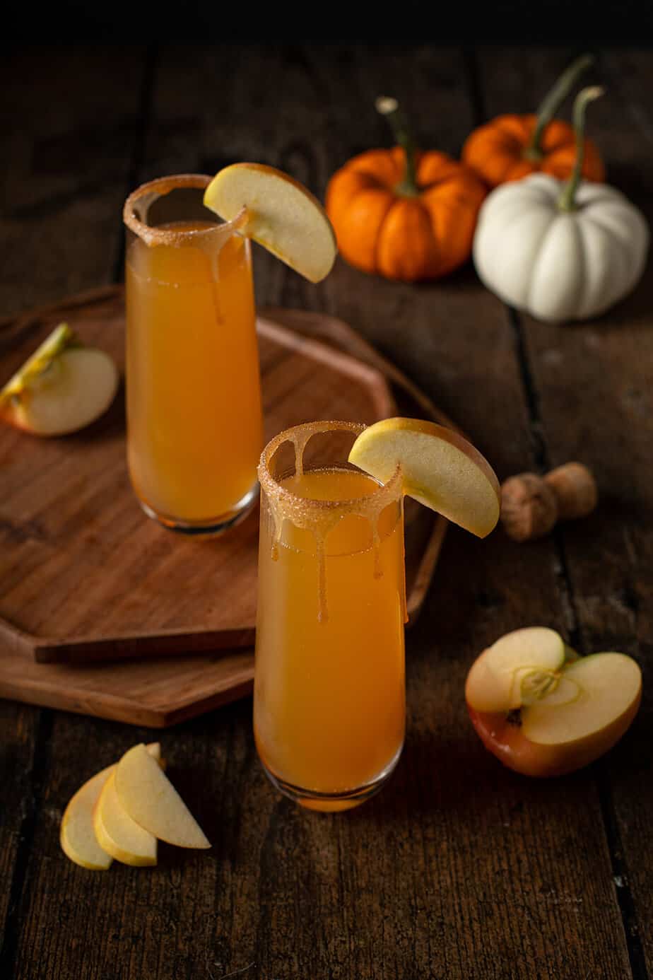 two stemless champagne flutes of apple cider mimosas