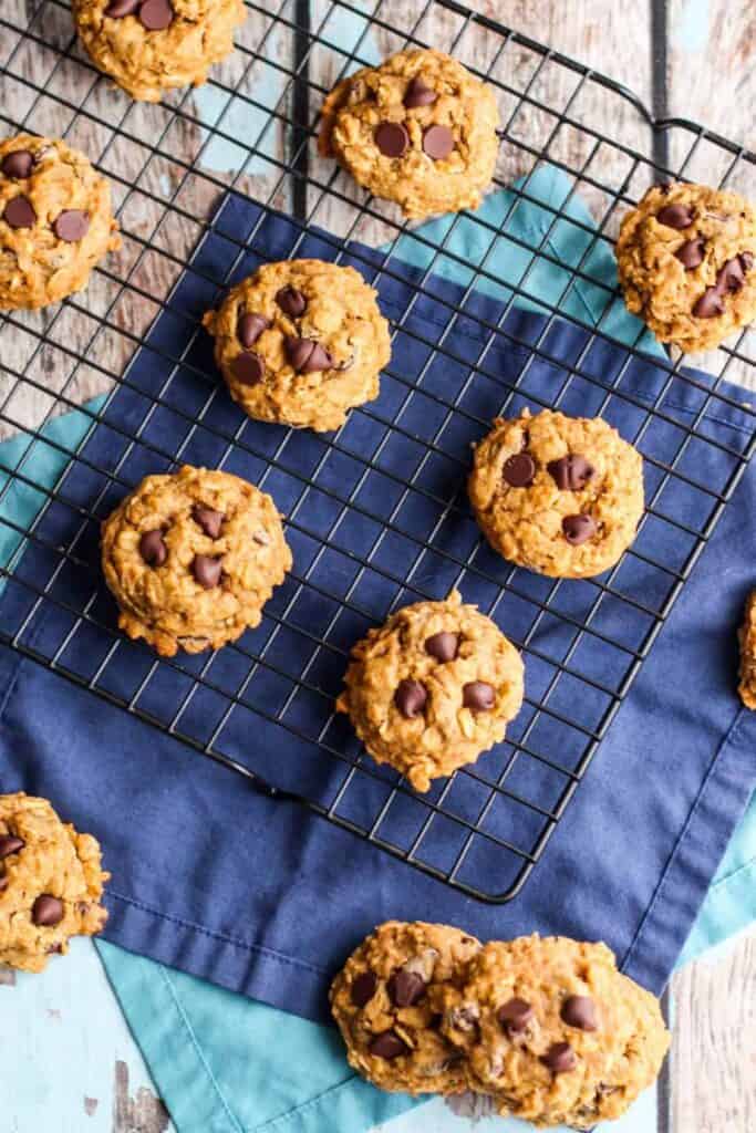 an overhead photo of pumpkin oatmeal chocolate chip cookies on a wire rack