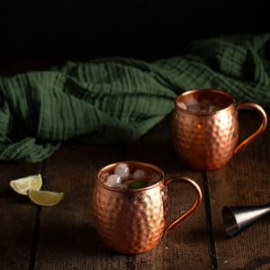 two copper mugs of bourbon mules.