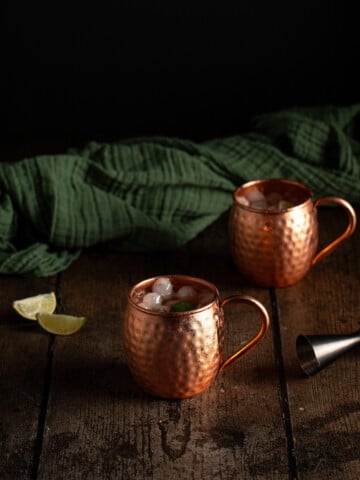 two copper mugs of bourbon mules.