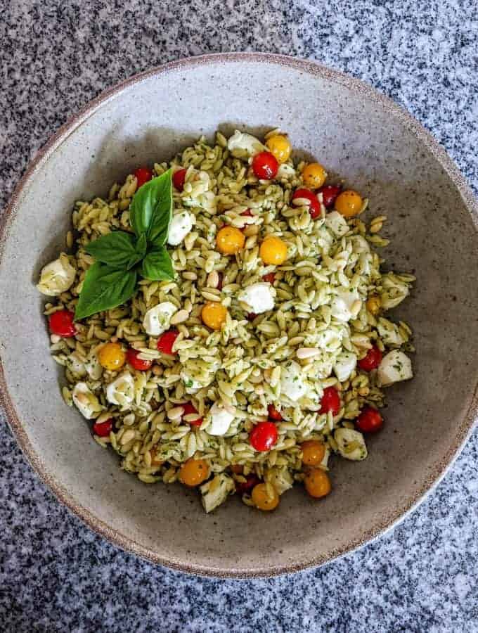 caprese orzo pasta salad in a serving bowl on a granite countertop
