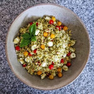 caprese orzo pasta salad in a serving bowl on a granite countertop