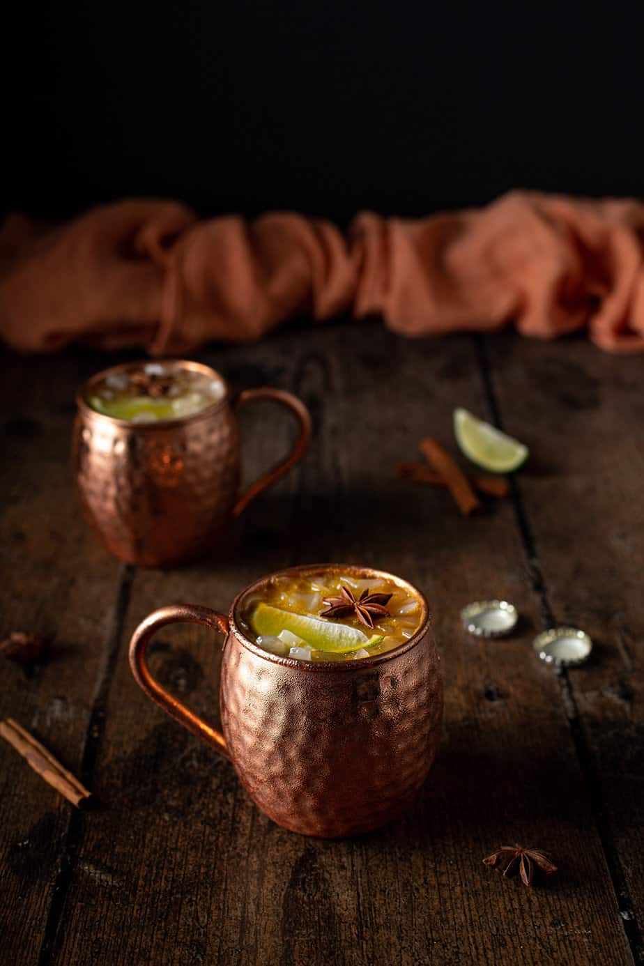 two copper mugs full of pumpkin pie moscow mules
