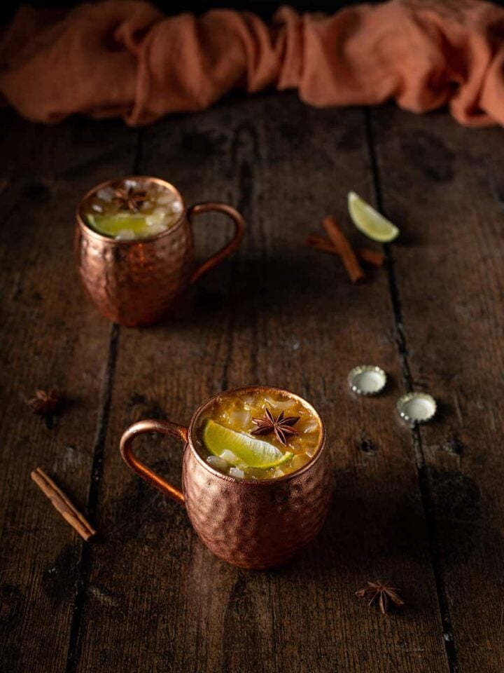 two copper mugs full of pumpkin pie moscow mules