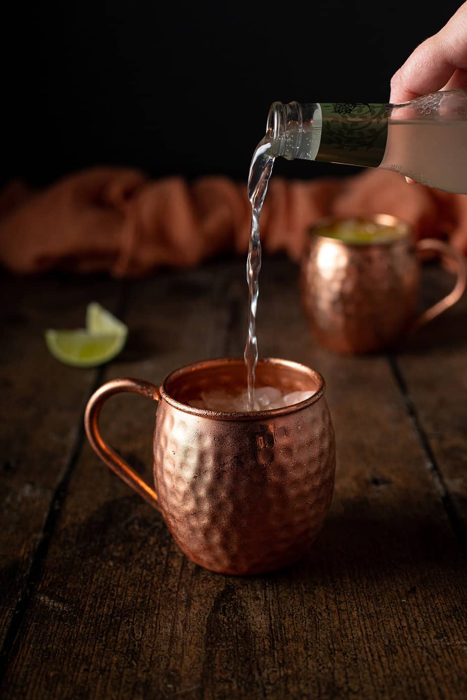 ginger beer being poured into a copper mug