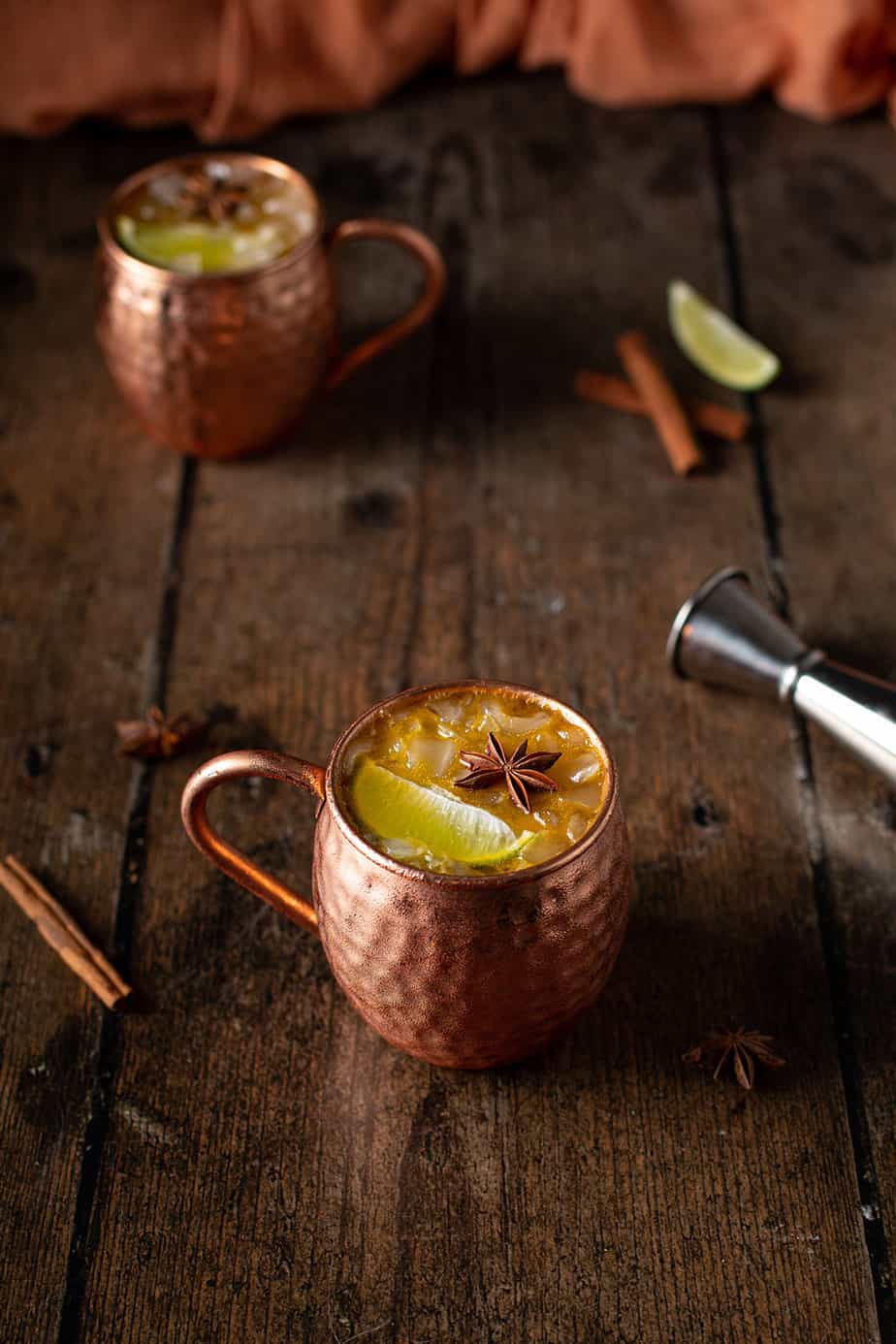two copper mugs full of pumpkin pie moscow mules
