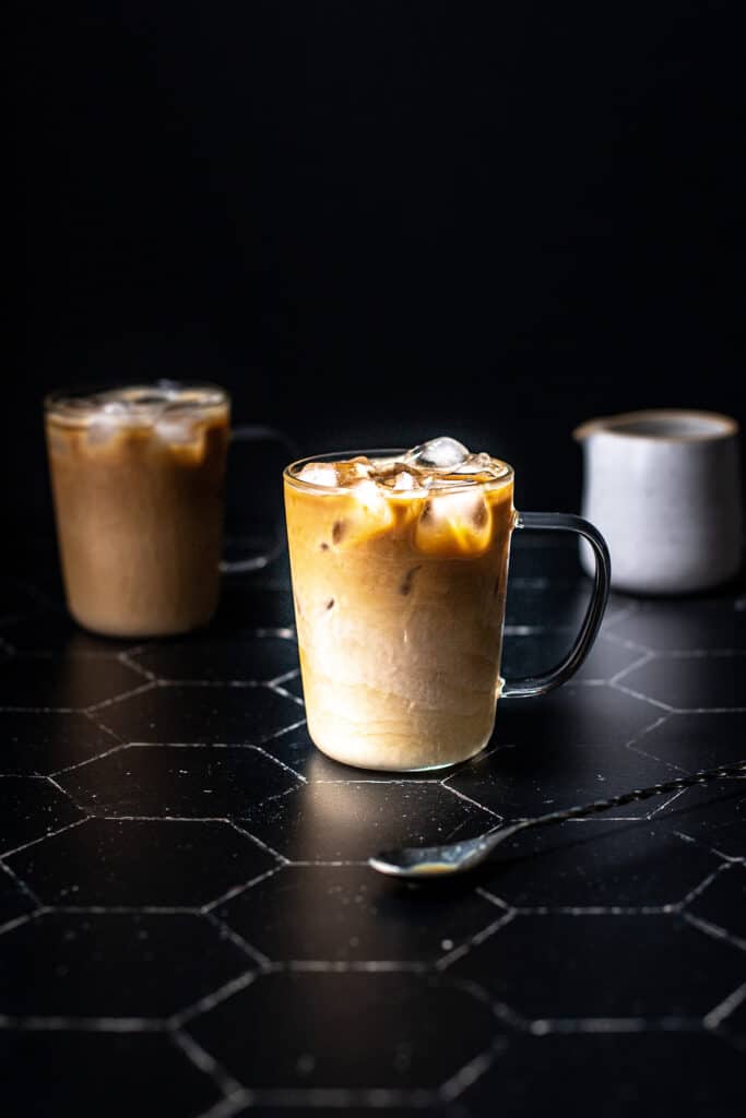 a clear glass mug filled with an iced latte