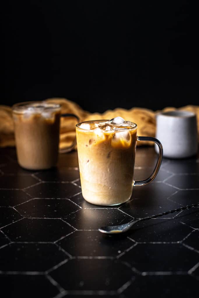 a clear glass mug filled with an iced latte