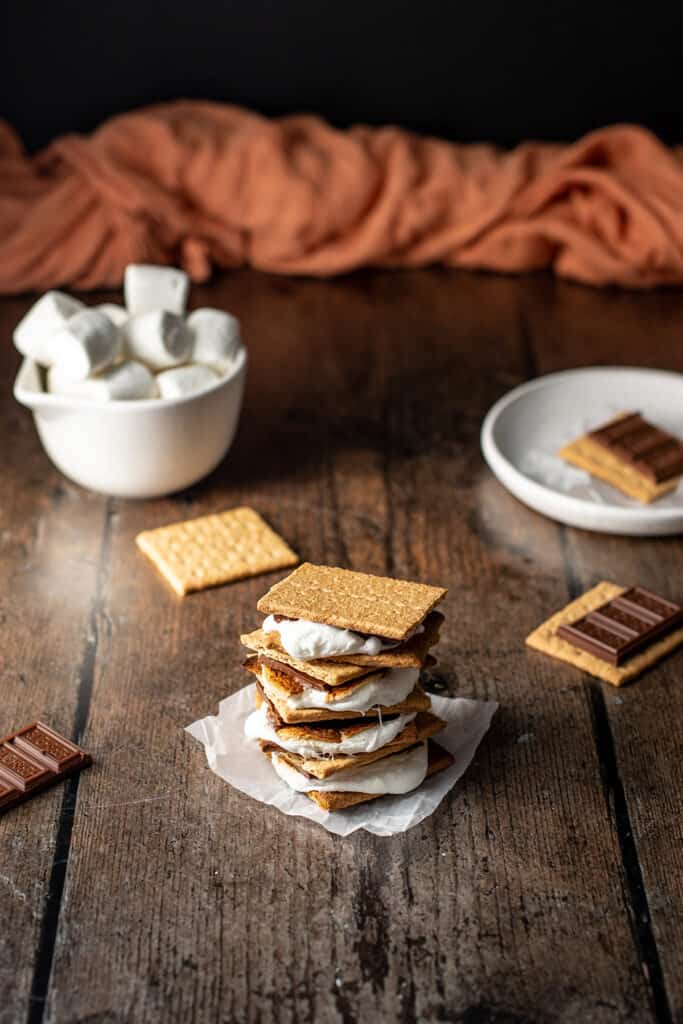 a stack of s'mores on a dark wooden background