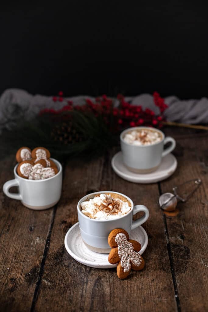 three mugs, two full of gingerbread lattes, the other full of gingerbread men