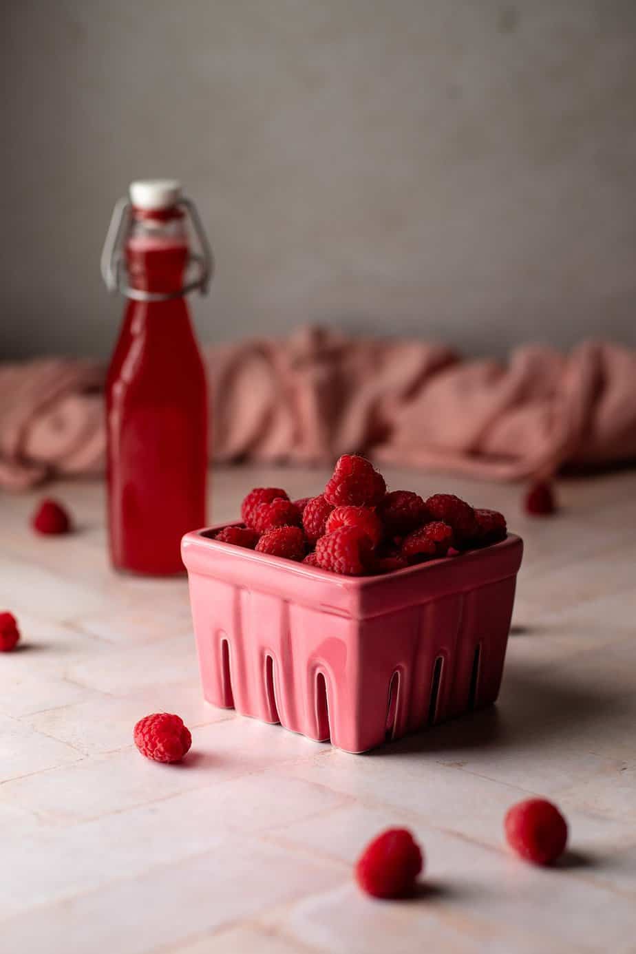 pink carton of red raspberries