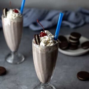 two cookies and cream milkshakes with blue straws