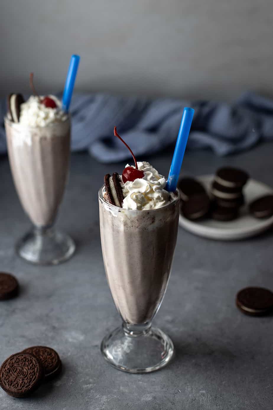 two cookies and cream milkshakes with blue straws