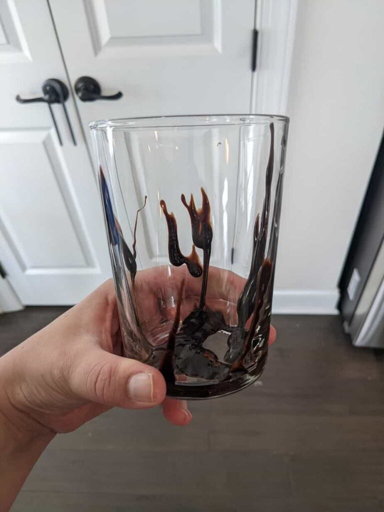 empty glass with chocolate sauce drizzled inside