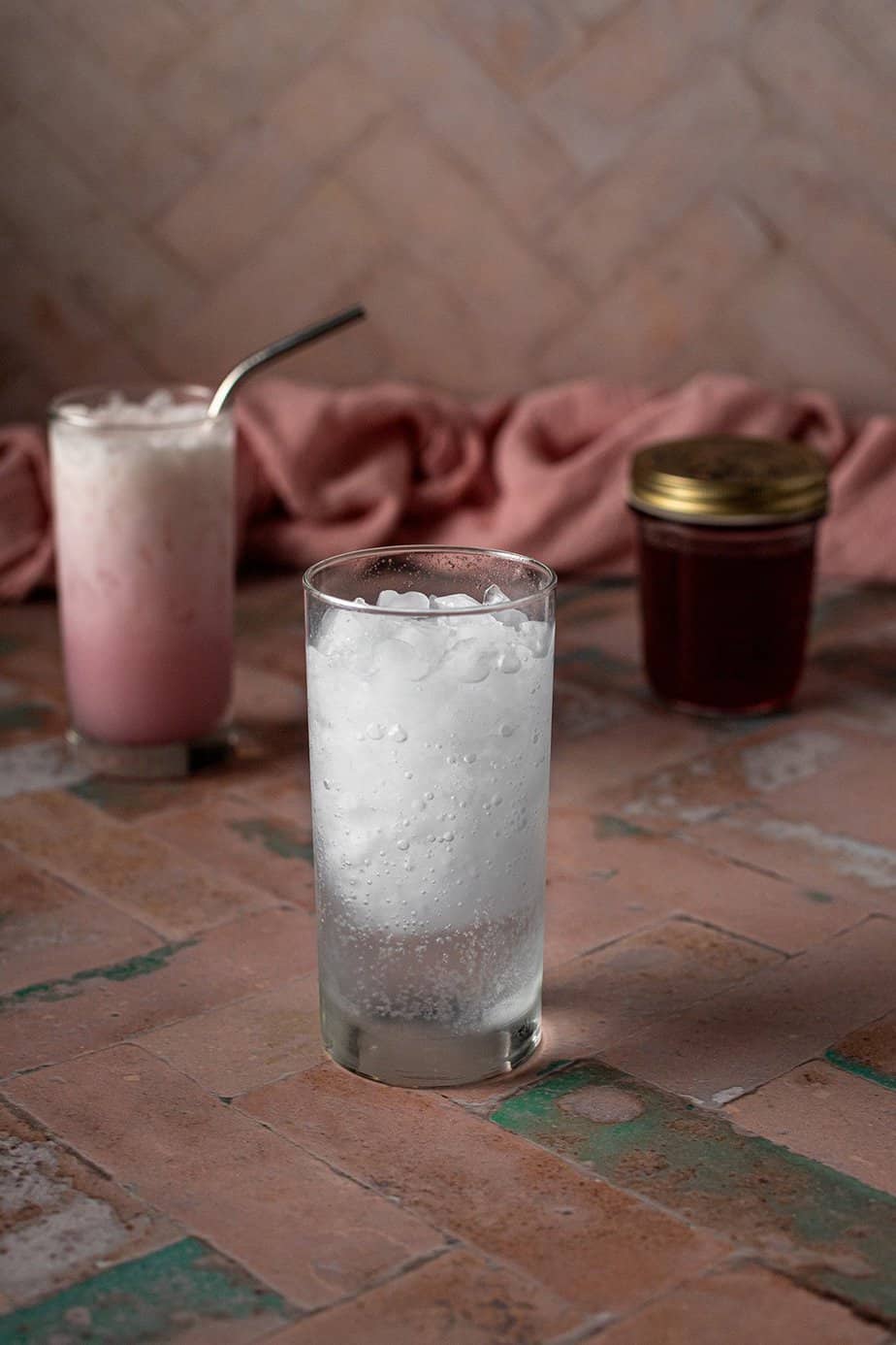 a tall glass with crushed ice and club soda