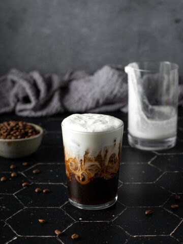 a glass of cold brew coffee topped with vanilla sweet cream cold brew