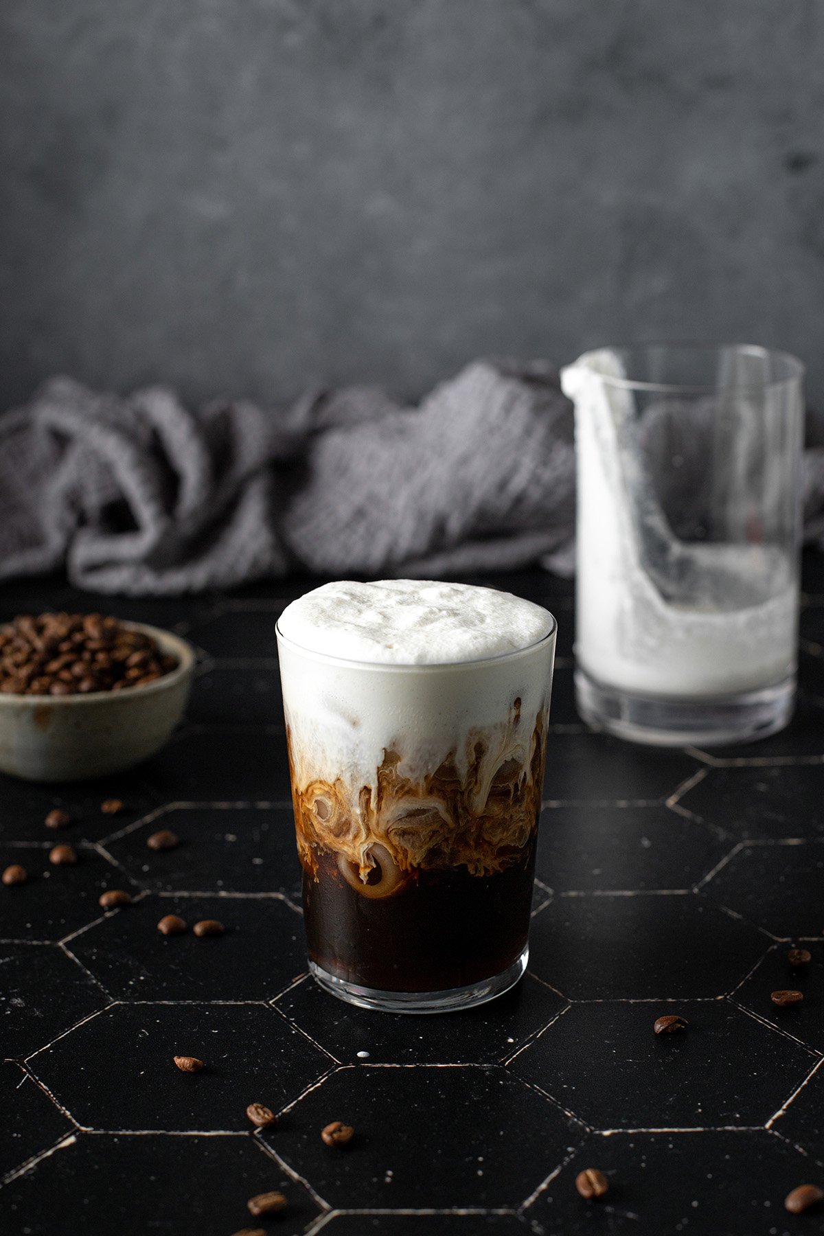 a glass of cold brew coffee topped with vanilla sweet cream cold brew