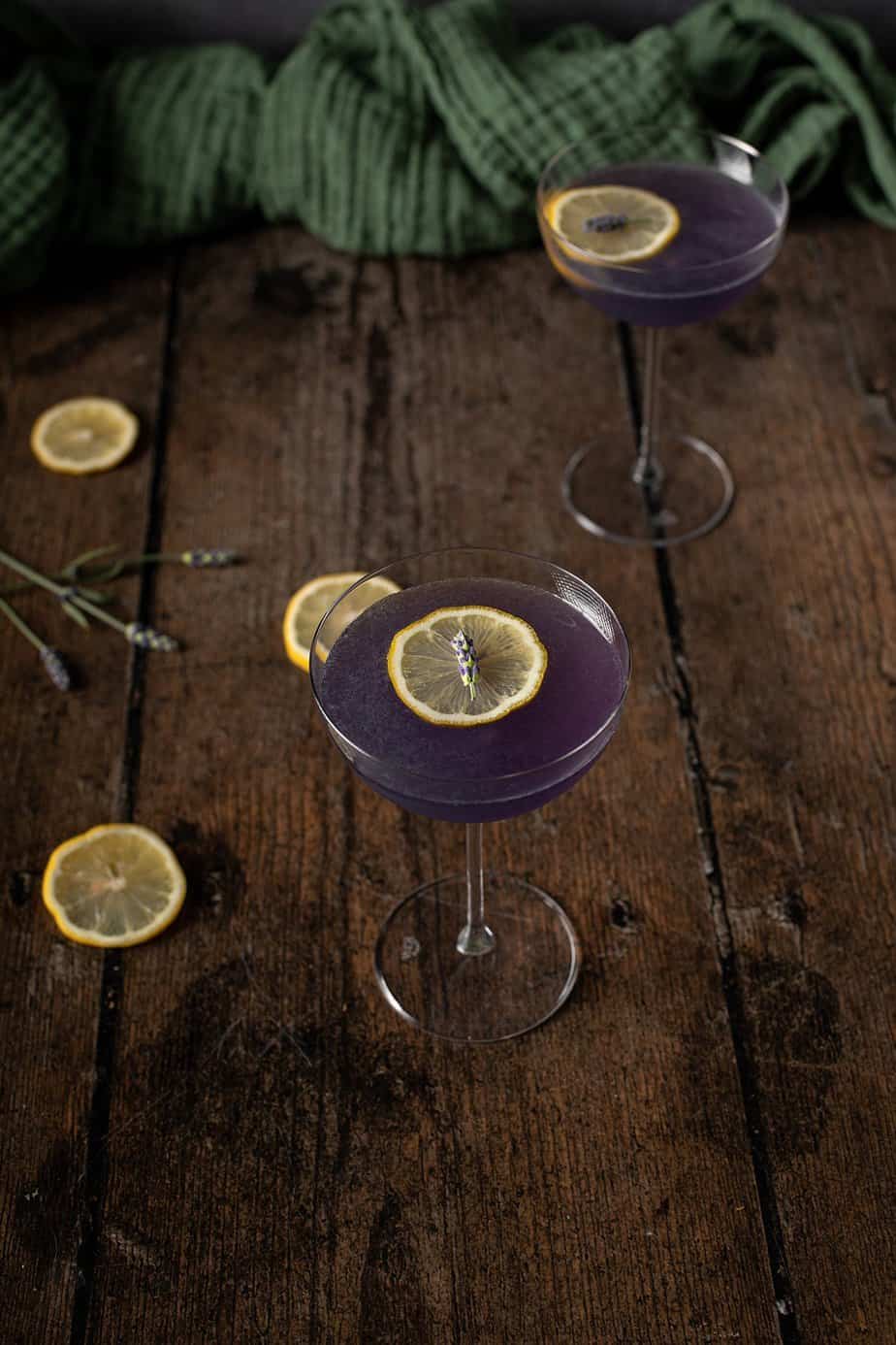 45 degree view of 2 coupe glasses full of lavender martinis