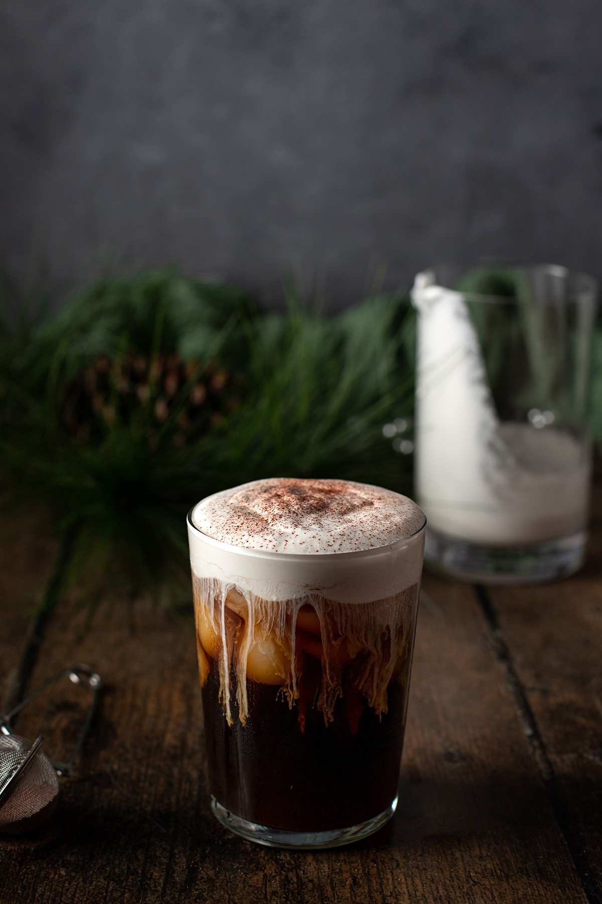 a glass of irish cream cold brew, dusted with cocoa powder