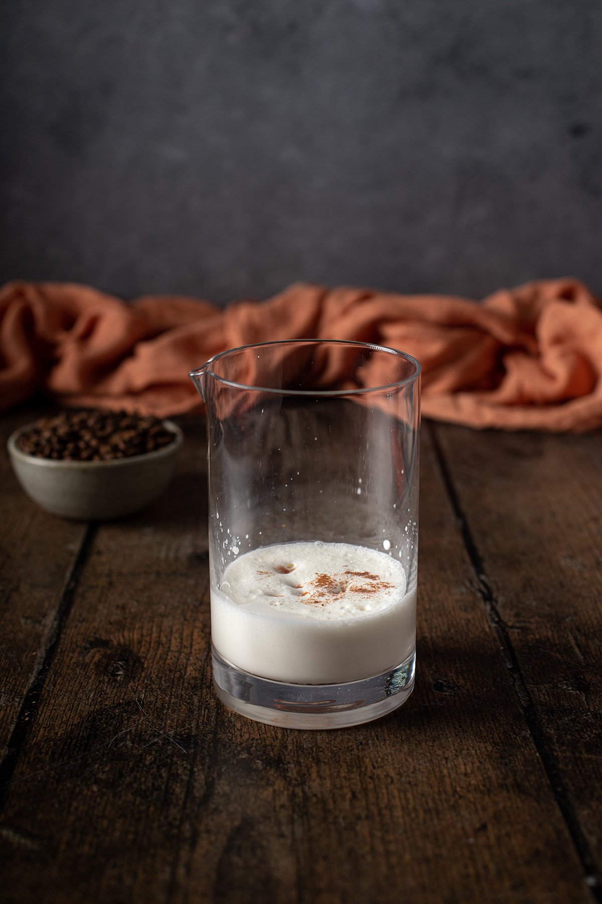 a glass with ingredients for pumpkin cream cold foam