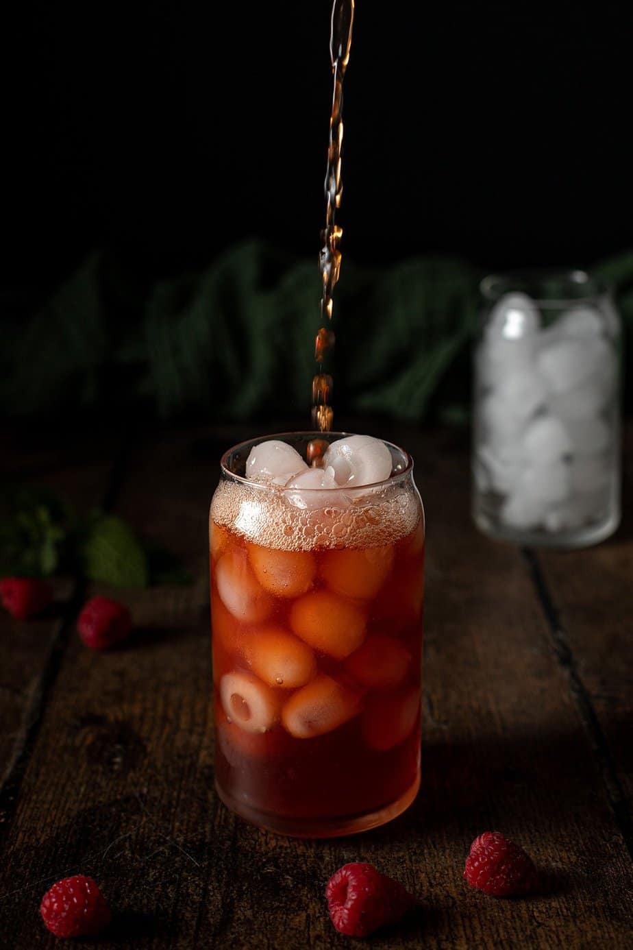 raspberry iced tea being poured into a glass