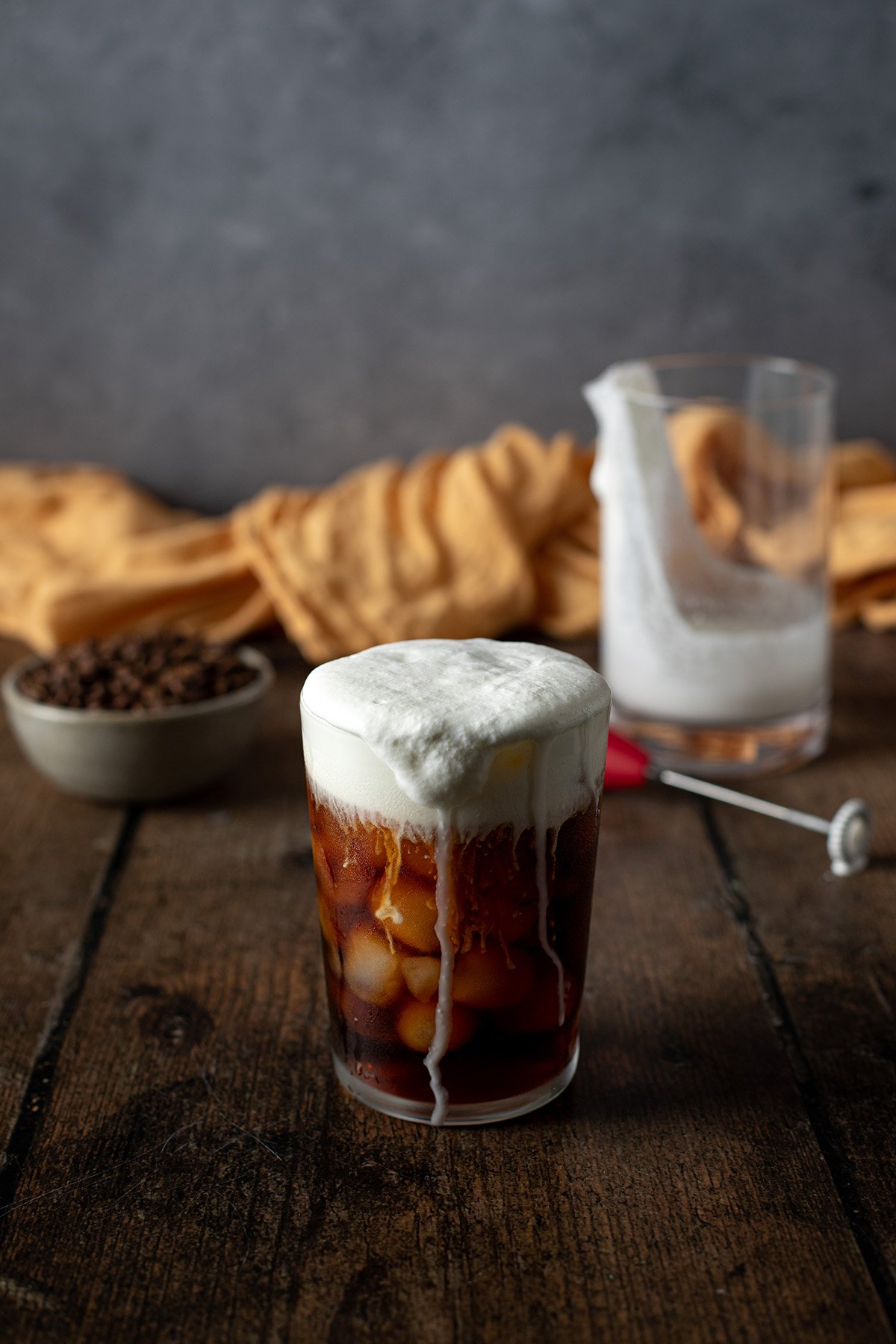 a glass of cold brew topped with salted caramel cream cold foam