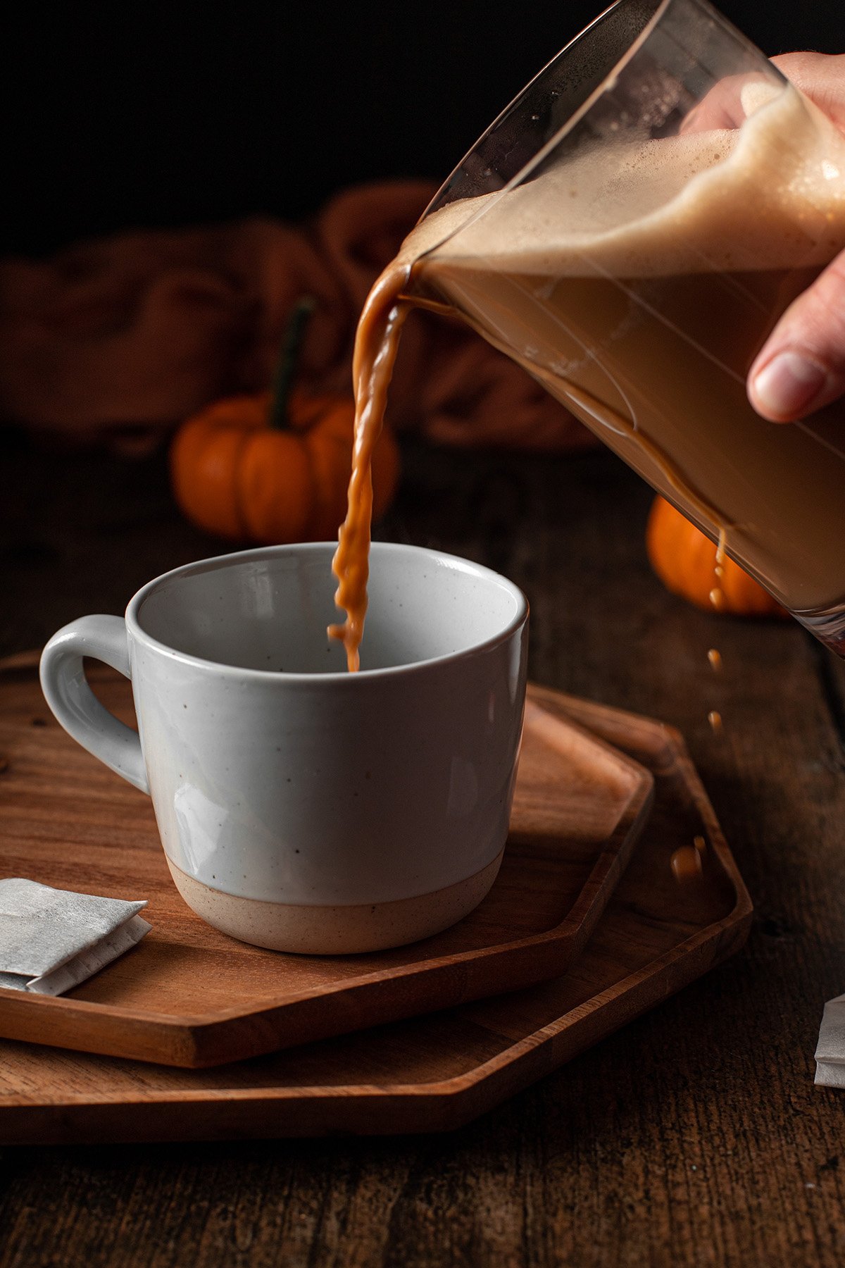chai being poured into a mug.