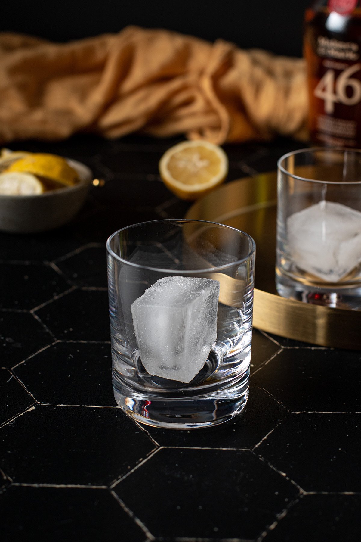 a large cube of ice in a rocks glass