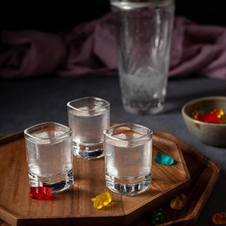 three shot glasses, each with gummy bear shot in it