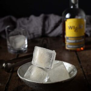 a bowl with three smoked ice cubes stacked up