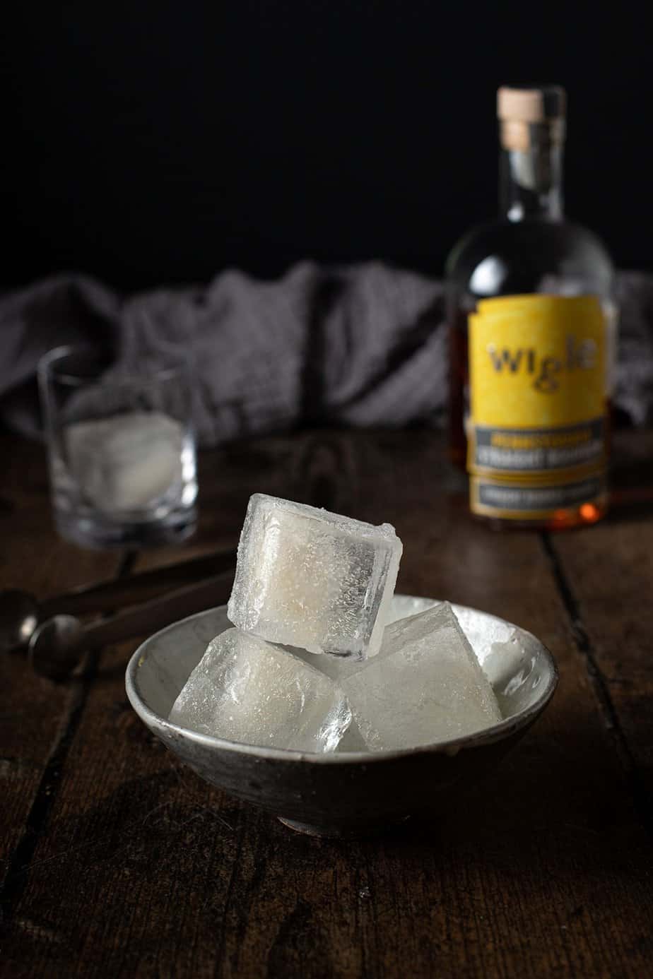 a bowl with three smoked ice cubes stacked up