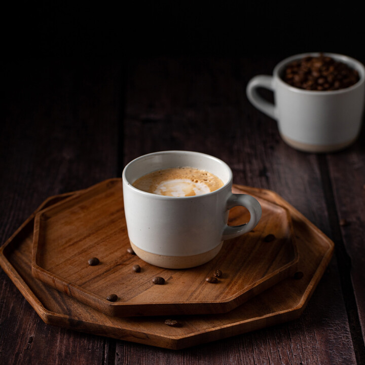 a mug full of blonde vanilla latte on a wooden tray