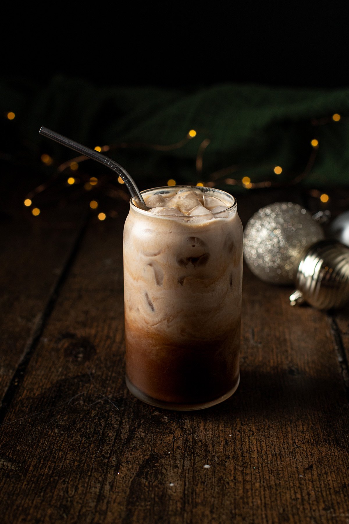 a glass of iced peppermint mocha with a metal straw