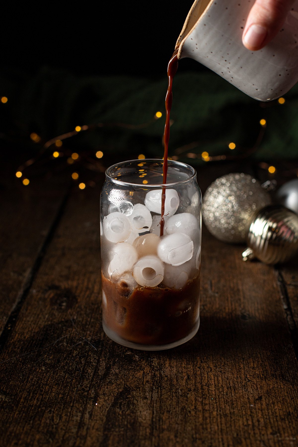 peppermint mocha being poured into a glass withice