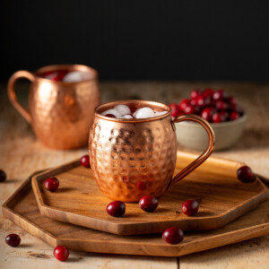 two copper mugs with cranberry moscow mules