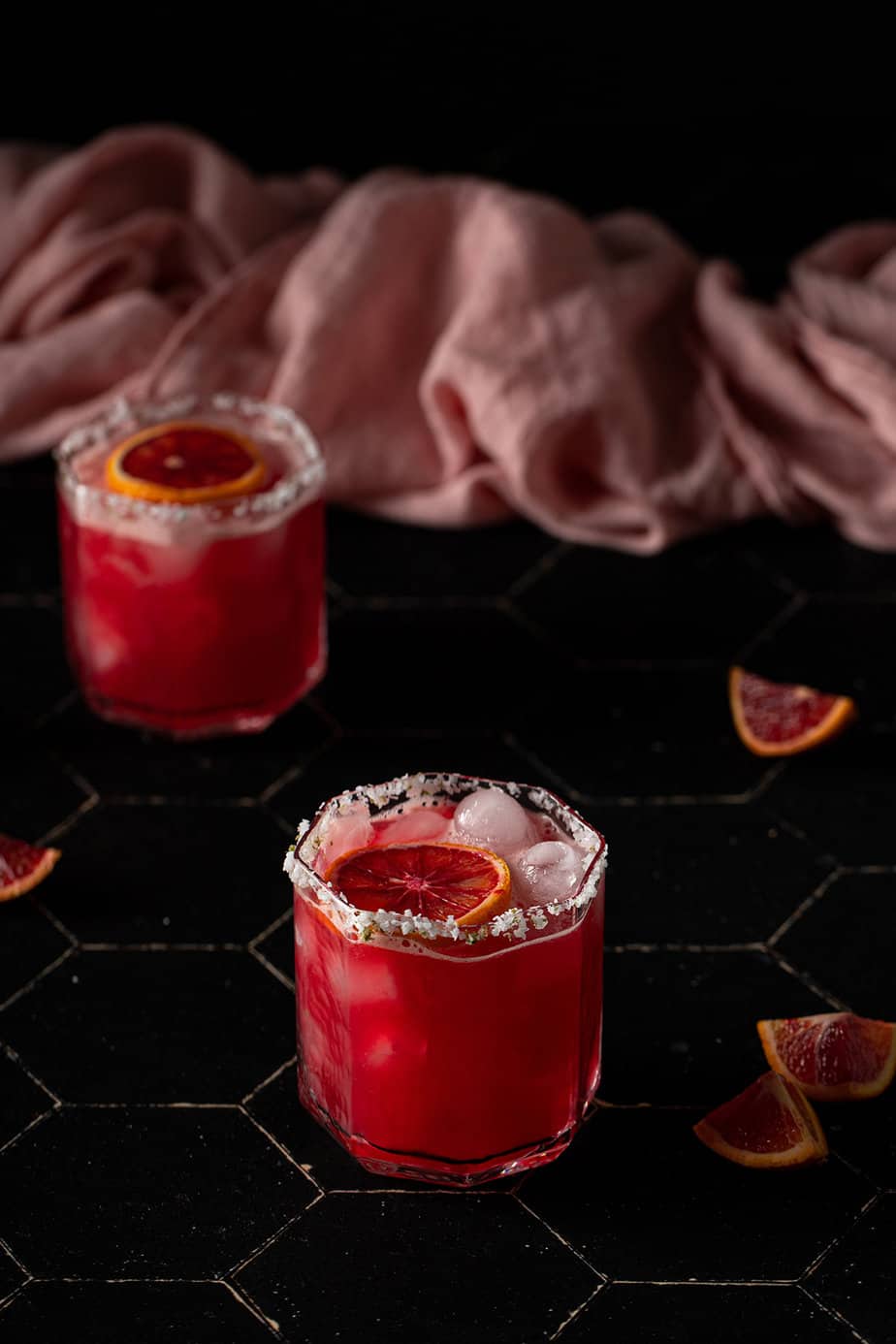 two short glasses filled with blood orange margaritas