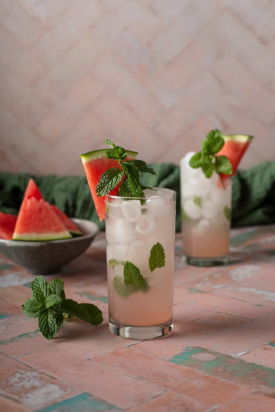 two watermelon mojitos in tall glasses