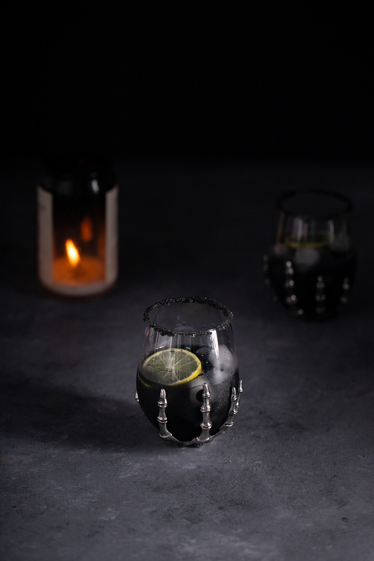 a black margarita in a halloween wine glass.