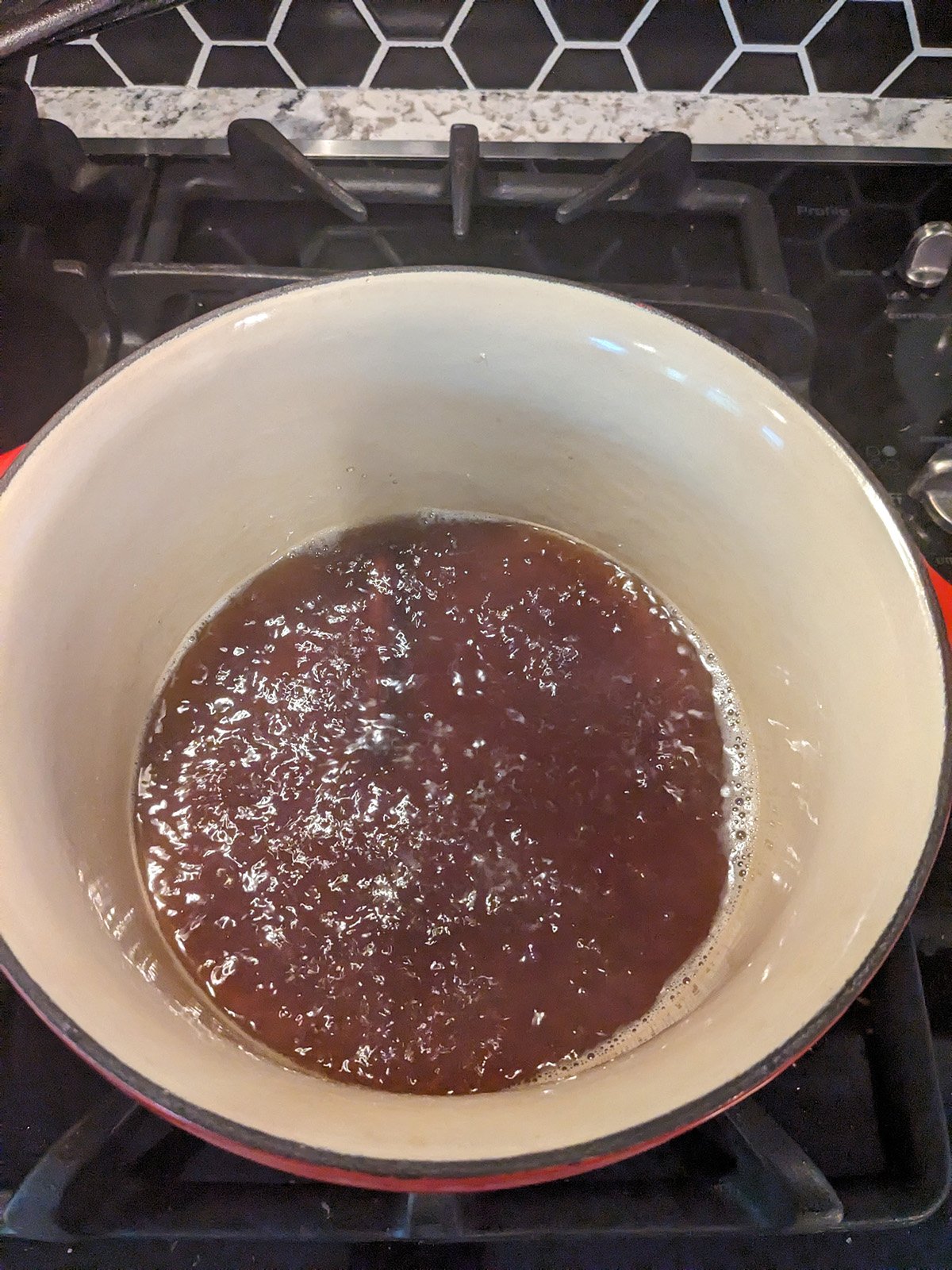 liquid for making bourbon cherries simmering in a saucepan.