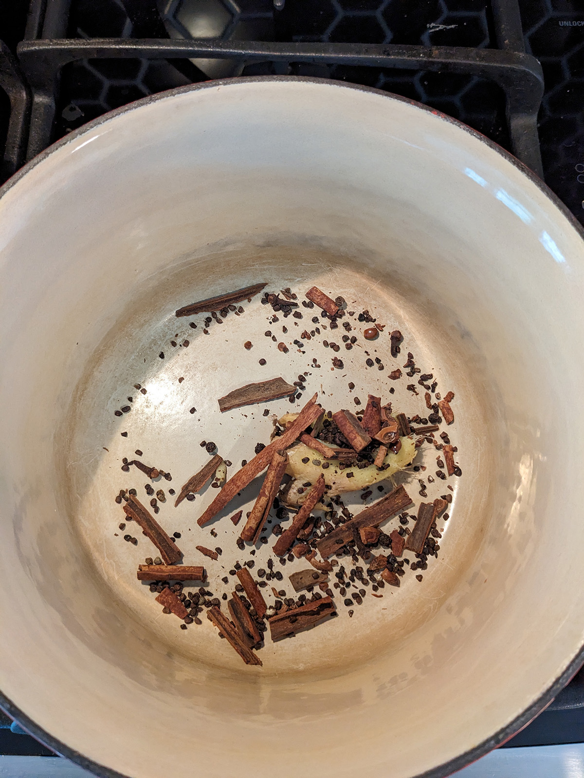 crushed spices and ginger in a saucepan.