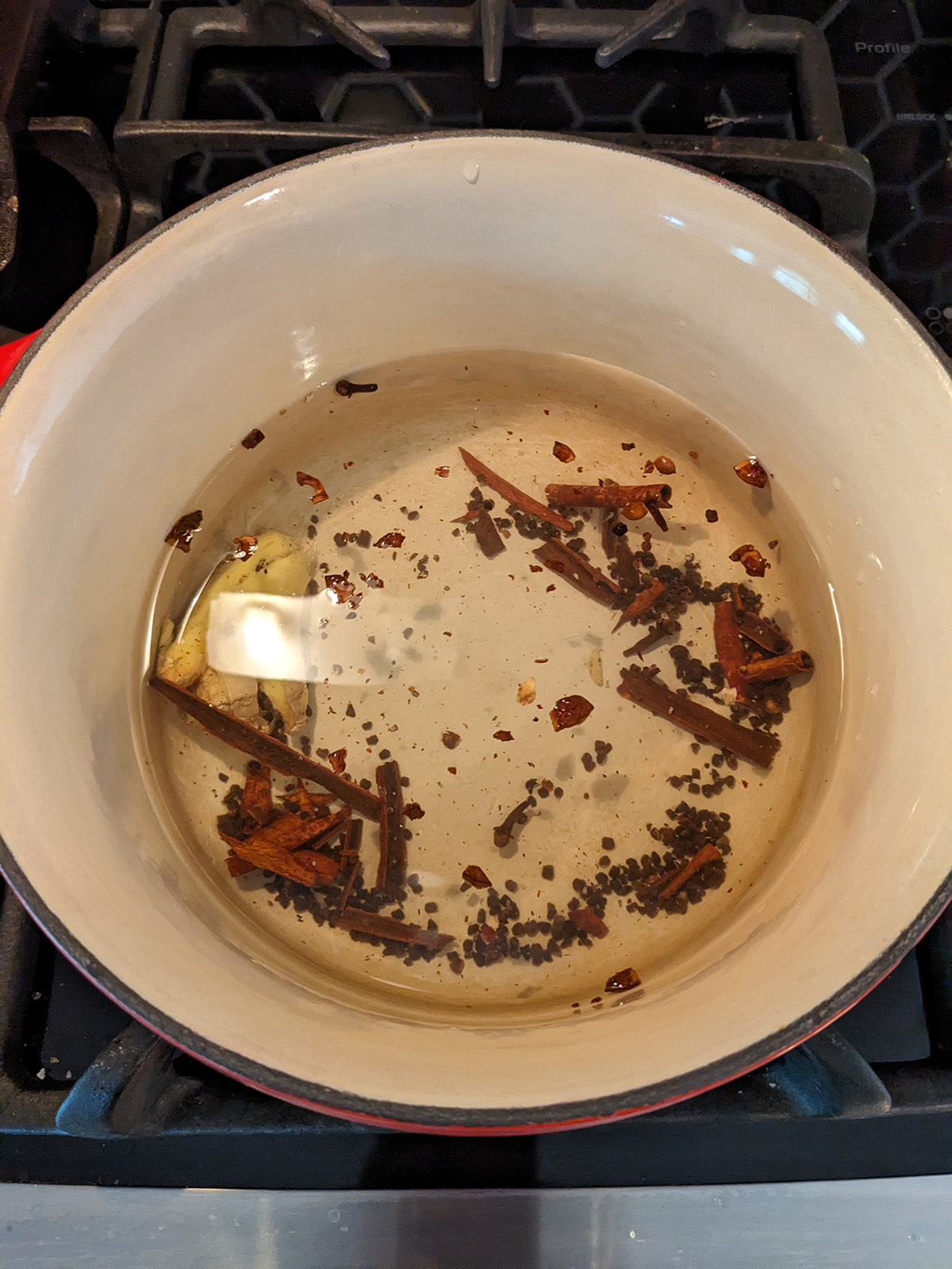 crushed spices and ginger in a saucepan with water.