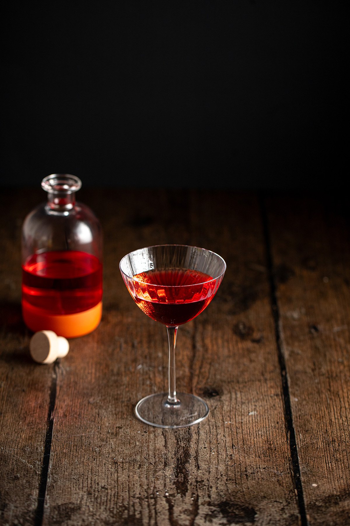 a coupe glass with raspberry vodka.