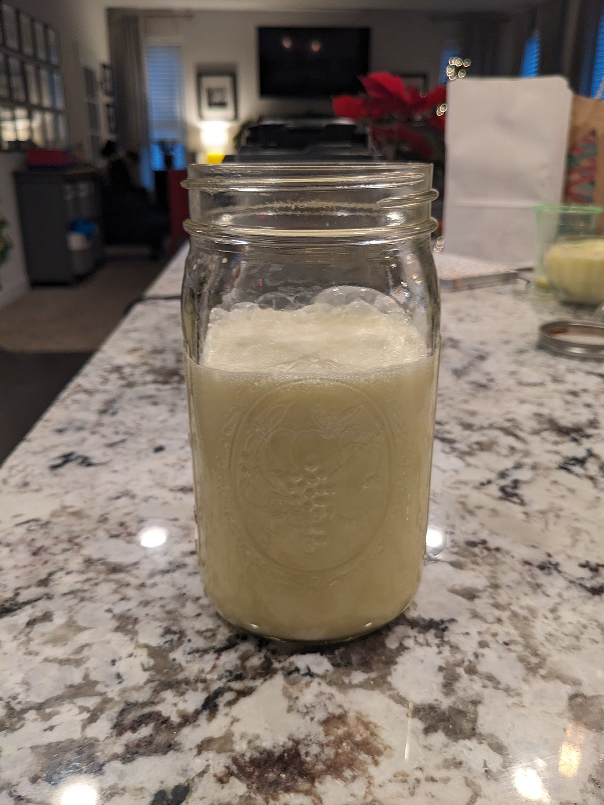 a mason jar full of uncooked eggnog.