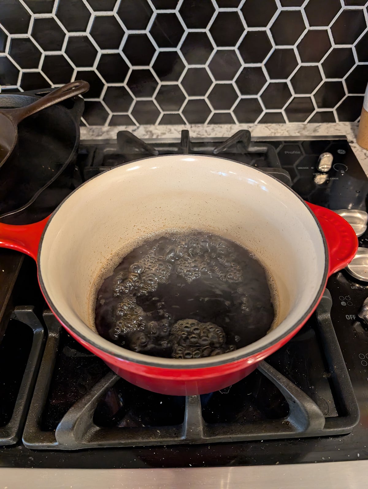 a saucepan with simmering water and brown sugar in int.