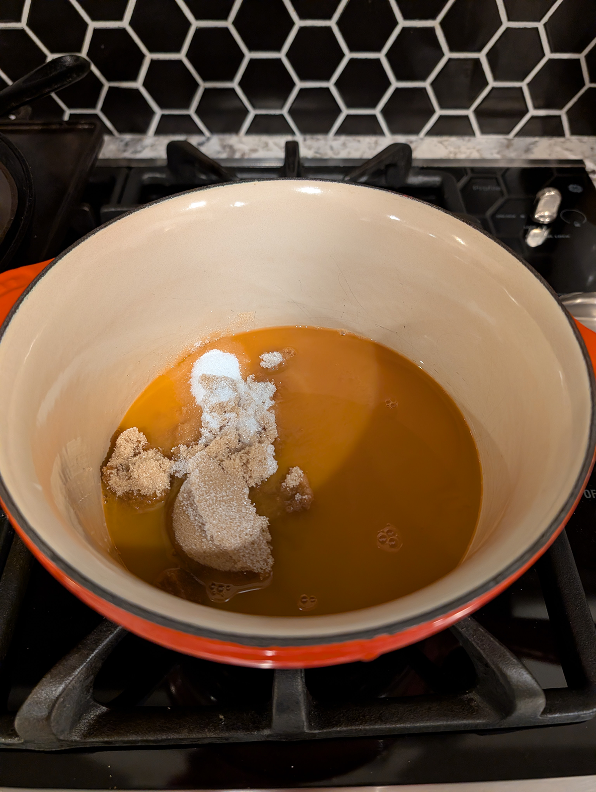 carrot juice and brown and white sugars in a saucepan.