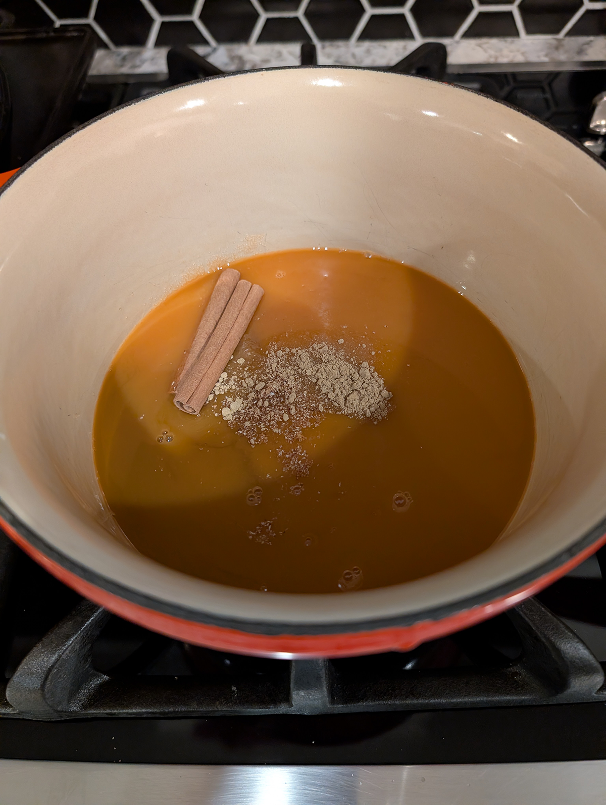 carrot juice, brown and white sugars, and spices in a saucepan.