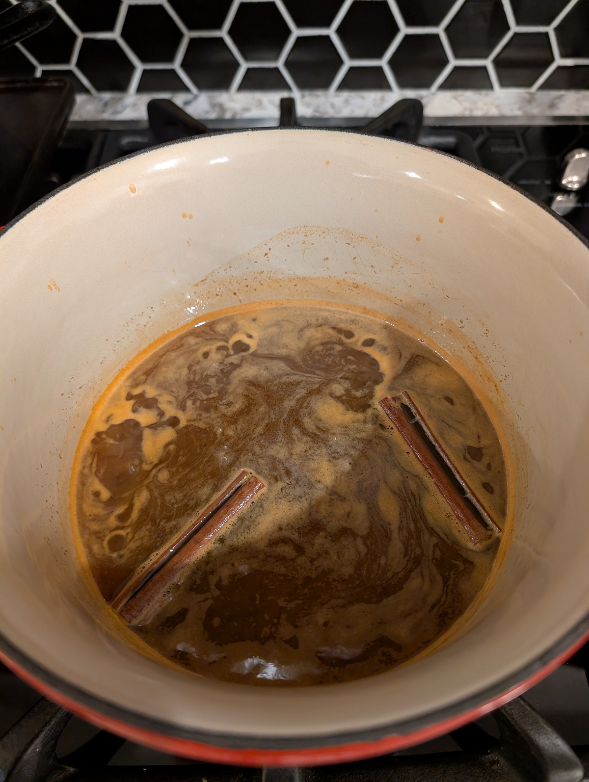 carrot cake syrup simmering in a saucepan.